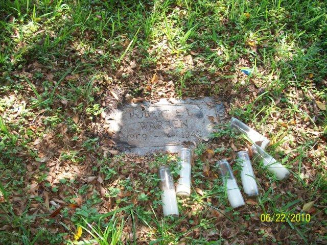 Partial headstone in unmarked cemetery, South Florida.